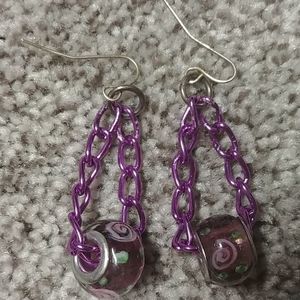 Purple floral earrings on purple chain